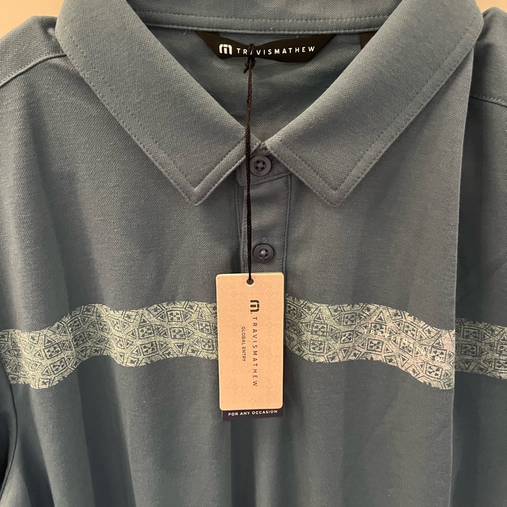 Brand new Travis Mathew Slate Blue Polo with Patterned Stripe